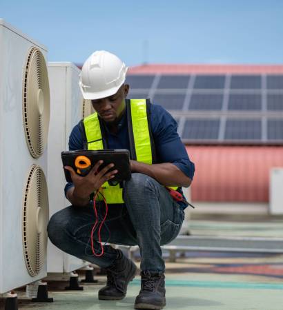 Engineers inspecting the air conditioning system in a large building or industrial facility.